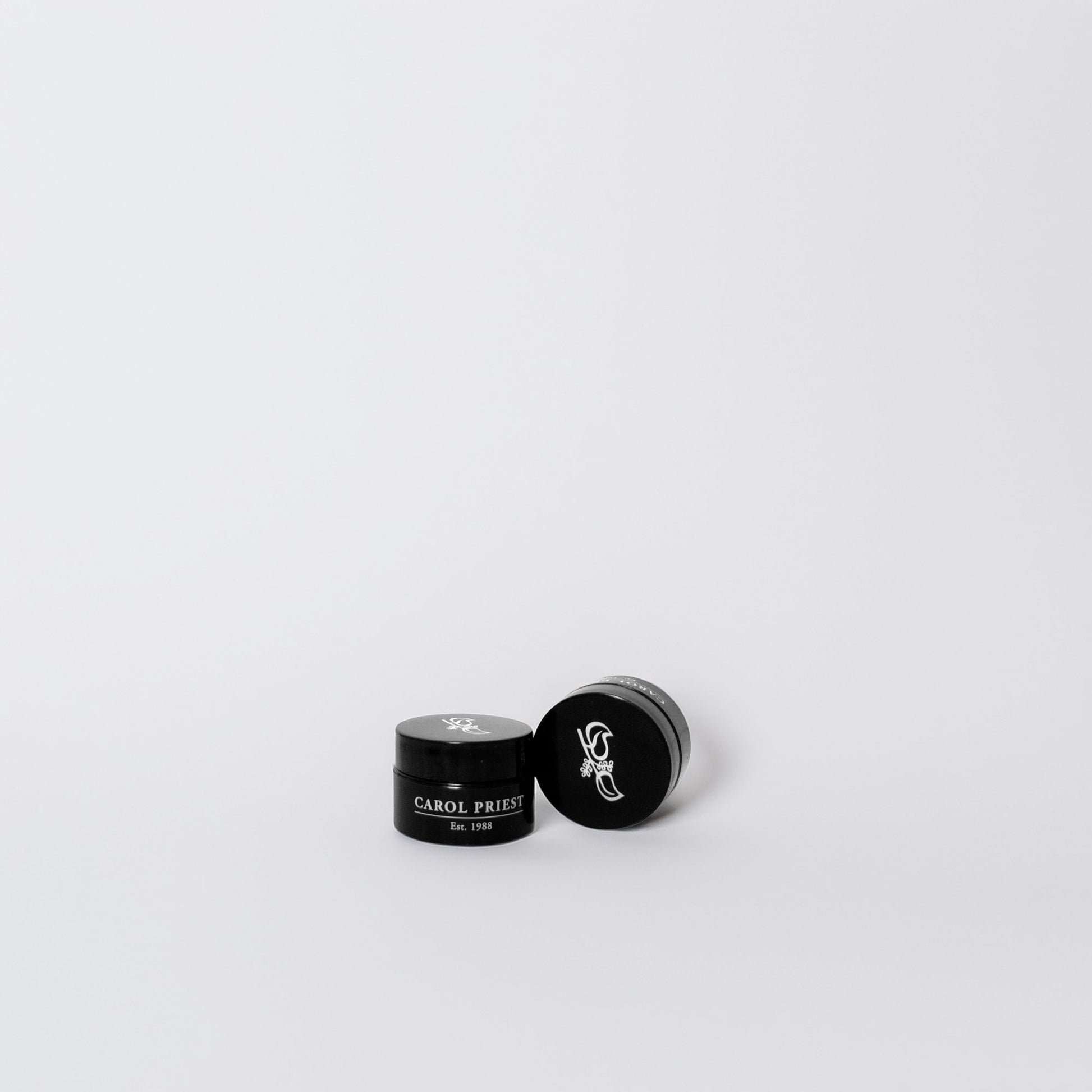 A collection of cosmetic samples featuring the logo of Carol Priest's natural and organic cosmetics.