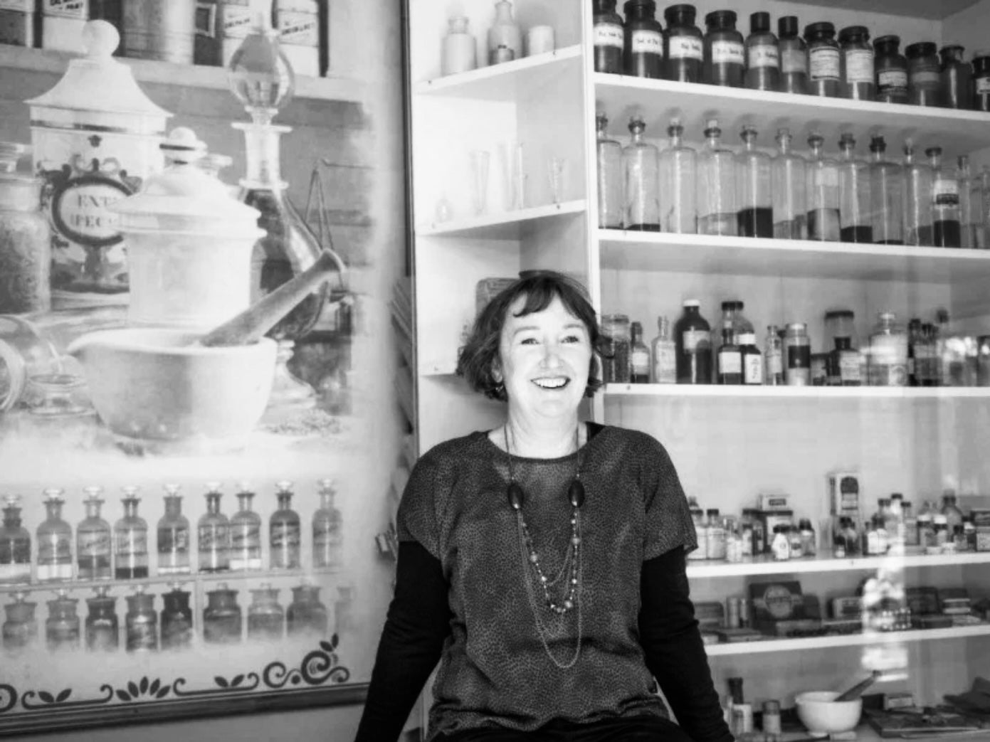 Founder Carol Priest radiating joy in the shop, reflecting the brand&#39;s vibrant essence and leadership.